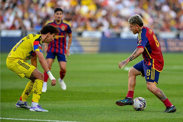 Real Salt Lake midfielder Diego Luna dribbles the ball defended by Club America defender Igor Lichnovsky during a Leagues Cup soccer match