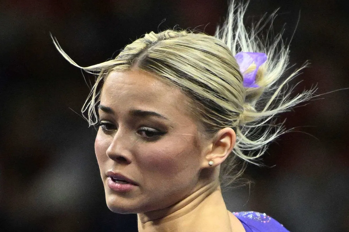 Olivia Dunne smash her feet on the low bar as she tries to deny the