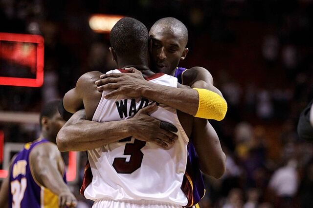 Miami Heat guard Dwyane Wade (3) is hugged by Los Angeles Lakers guard Kobe Bryant following an NBA basketball game in Miami