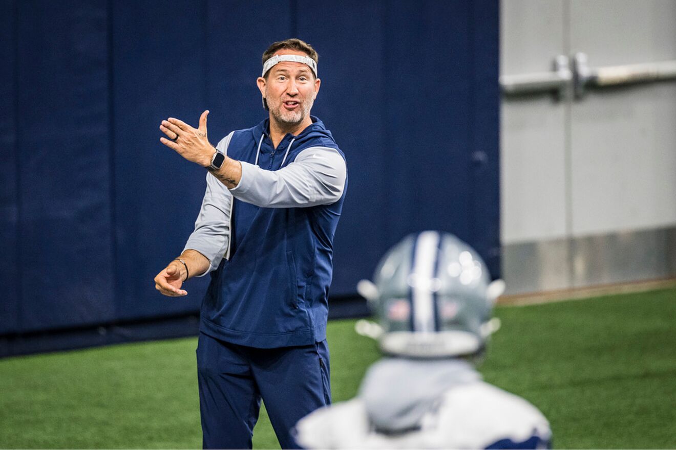 Dallas Cowboys head coach Brian Schottenheimer talks to a player