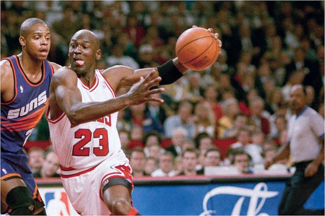 Chicago Bulls forward Michael Jordan (23) drives to the hoop against the Phoenix Suns Richard Dumas.