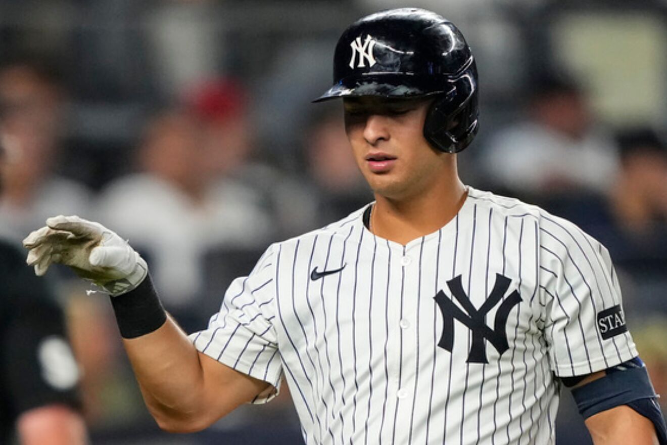 New York Yankees' Anthony Volpe (11) drops a bat after striking out...